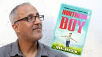 Blackburn-born author Iqbal Hussain holding his novel Northern Boy ahead of his event at Blackburn Central Library
